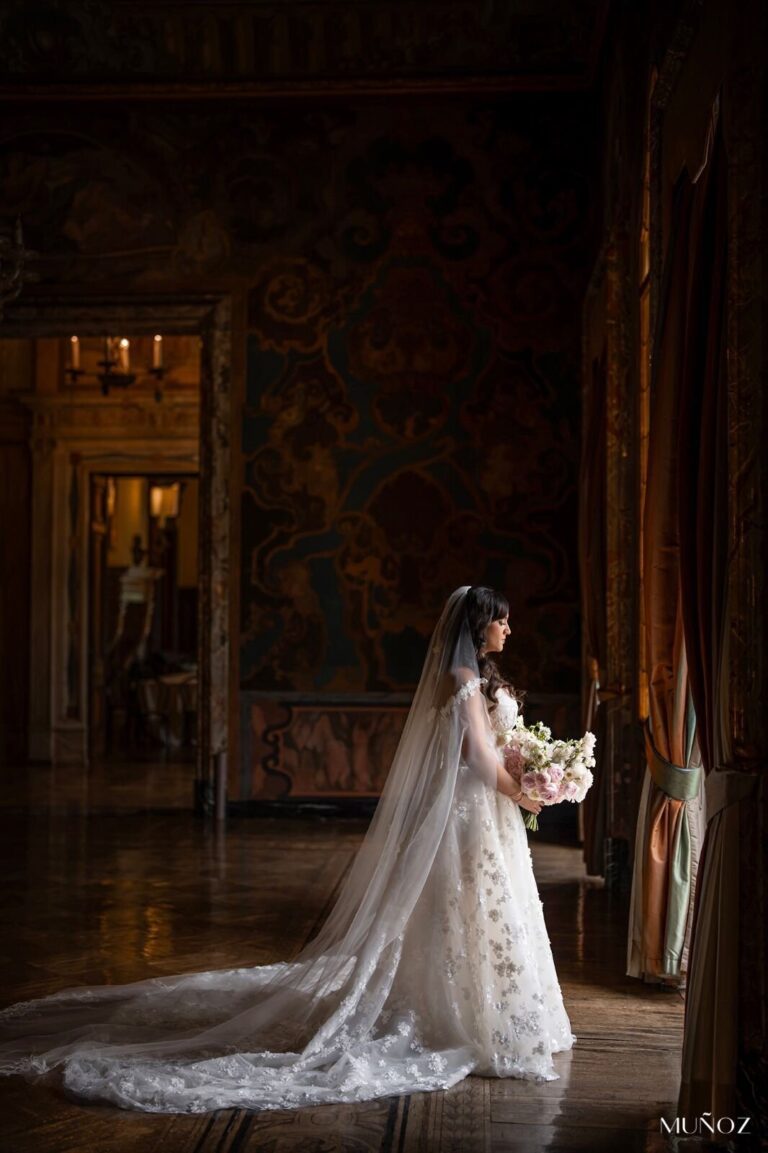 Bride in a lace veil in a dark panelled interior, Patrizia Cilli Events Italy