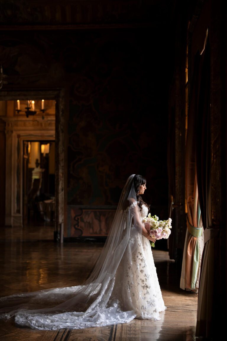 Bride in a long veil by a window in a historic interior, Patrizia Cilli Events Italy