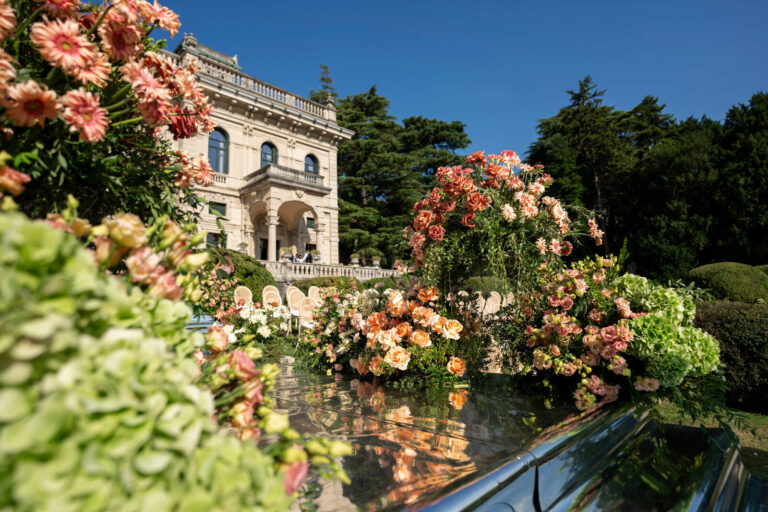 Terrace of peach and orange blooms in front of a lakeside villa, Patrizia Cilli Events Italy