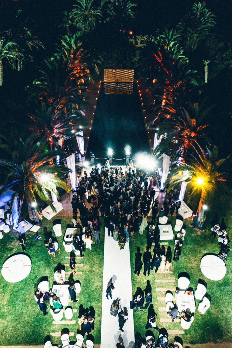 Evening reception seen from above, guests along a lit lawn aisle, Patrizia Cilli Events Italy