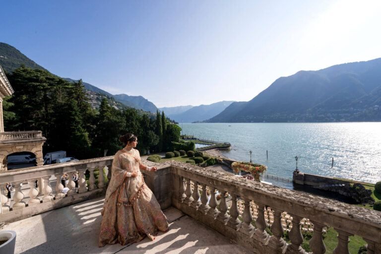 Bride in gold on a balustraded terrace above the lake, Patrizia Cilli Events Italy