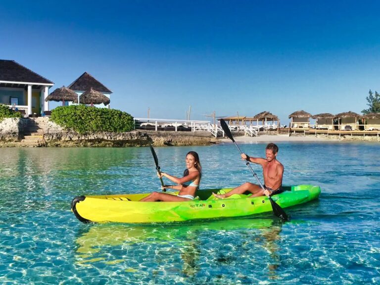 A couple kayaking in clear water, Pearl Island Bahamas