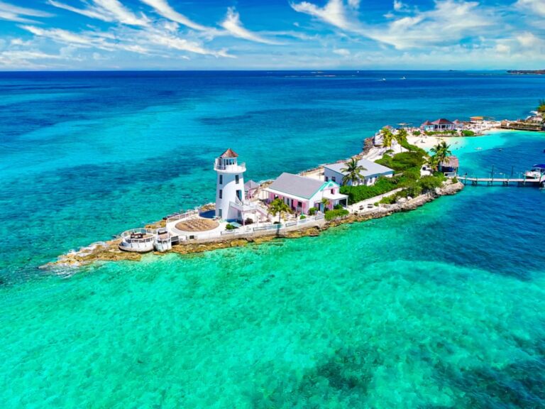 Aerial view of the lighthouse, turquoise reef water and island, Pearl Island Bahamas