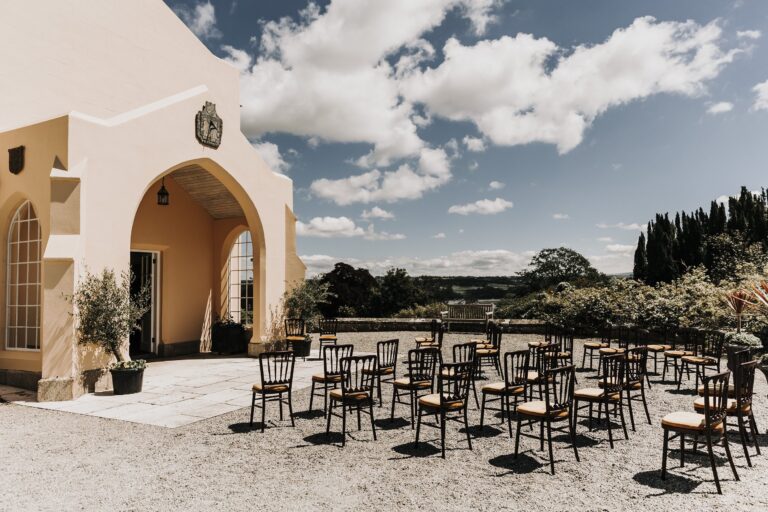 The orangery terrace set for a ceremony, countryside beyond, Pentillie Castle