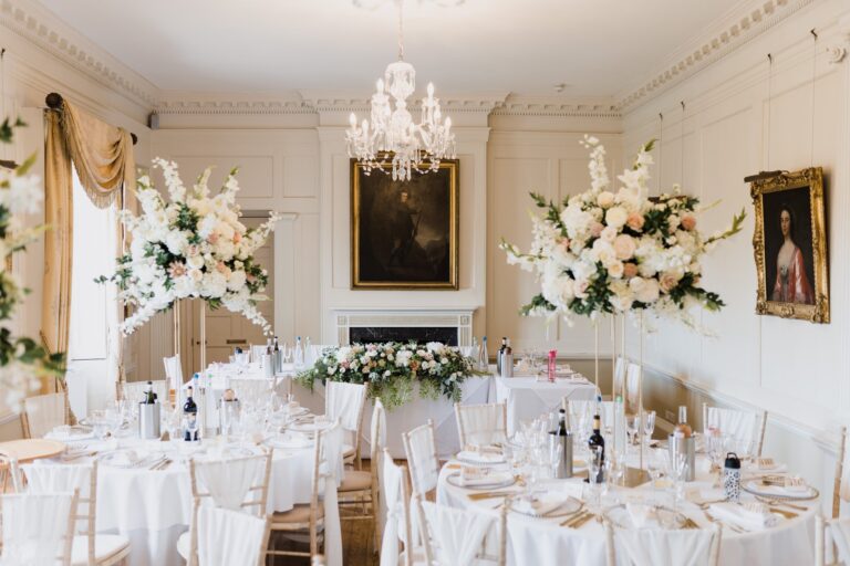 The dining room dressed for a wedding breakfast, florals and portraits, Pentillie Castle