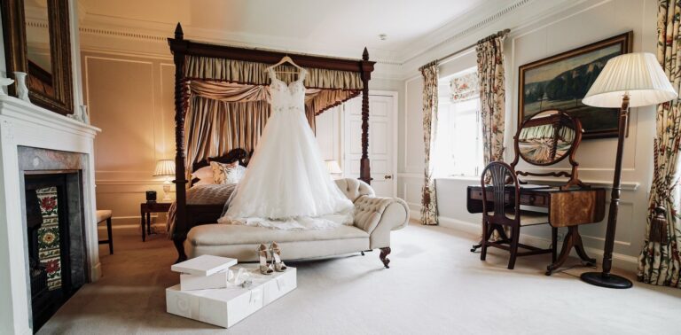 The bridal suite, a four-poster and the dress hanging ready, Pentillie Castle