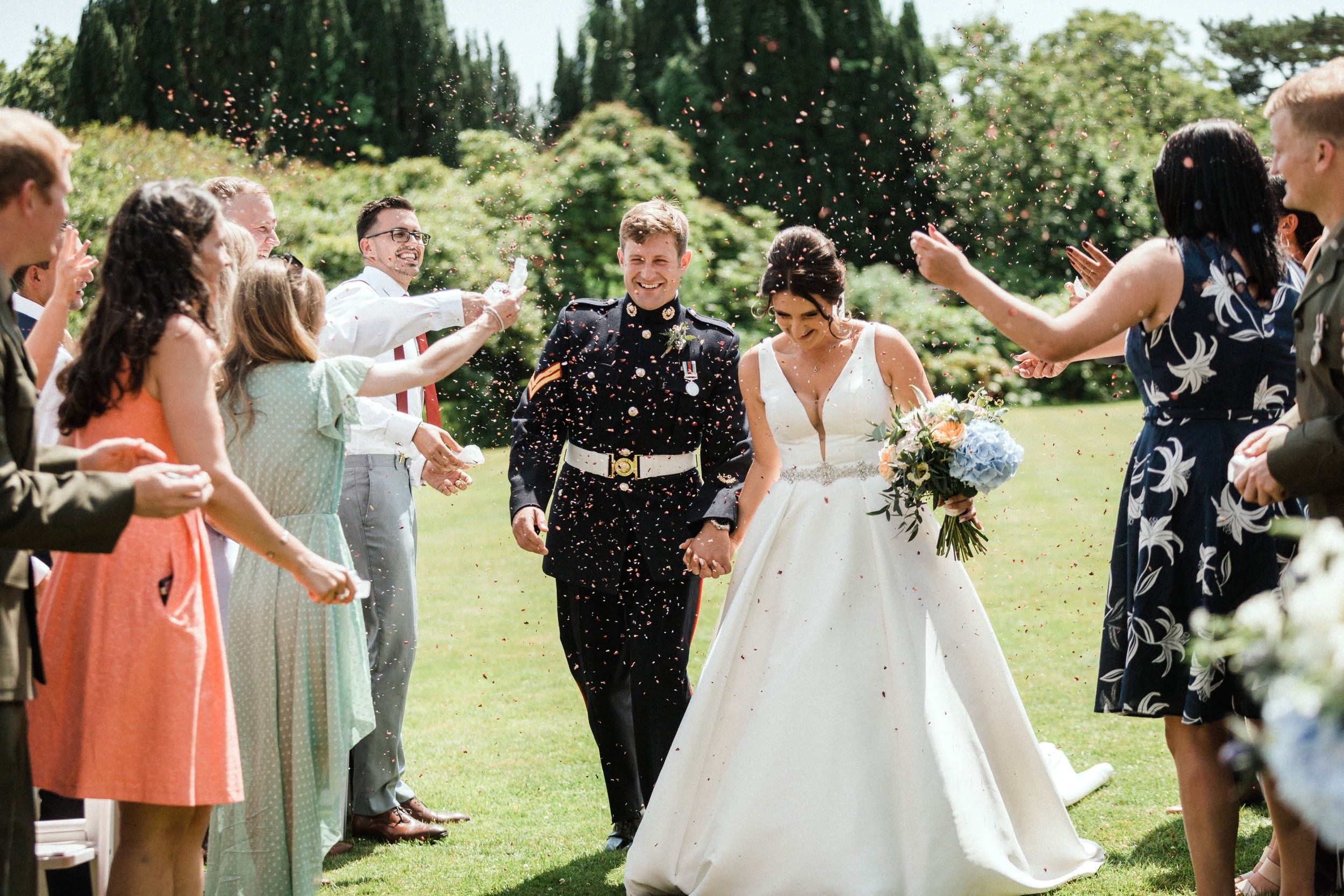 Confetti as the newlyweds walk through their guests, Pentillie Castle