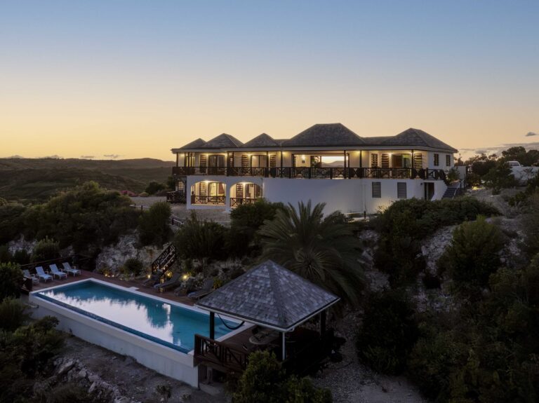 The villa lit at dusk above the pool and gazebo, Perfect Sunshine Antigua