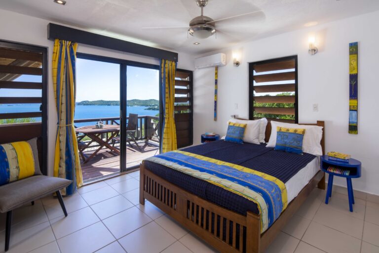 Bedroom with yellow and blue bedding and balcony doors, Perfect Sunshine Antigua