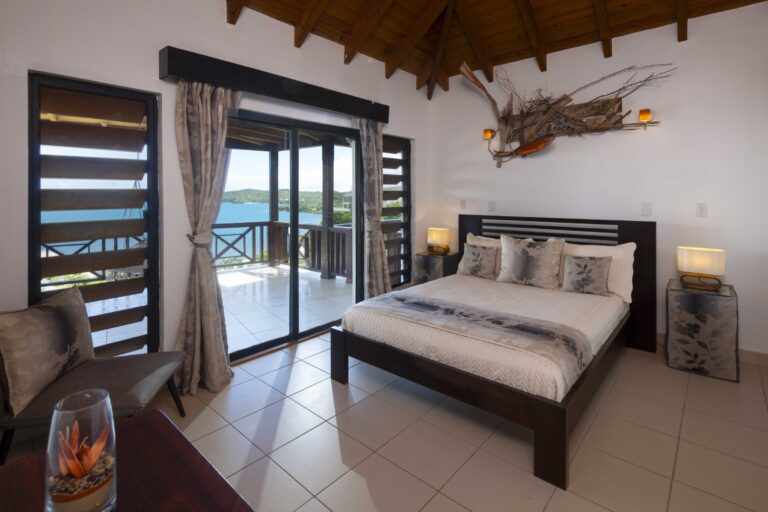 Bedroom with a king bed and sea views through the sliding doors, Perfect Sunshine Antigua
