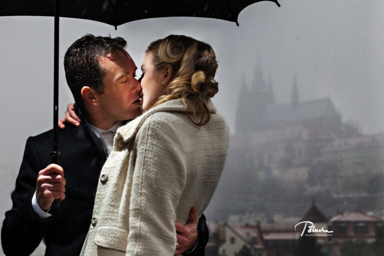 Couple kissing under an umbrella in the mist, Prague Castle behind, Petr Pelucha Photography