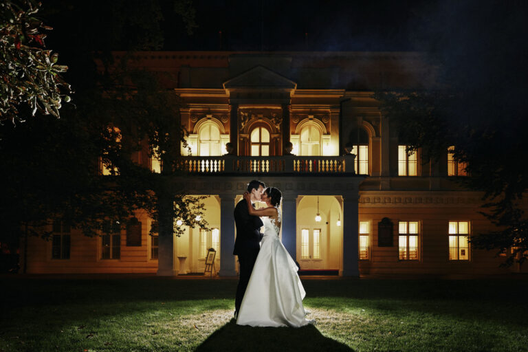 Couple on the lawn in front of an illuminated villa at night, Petr Pelucha Photography