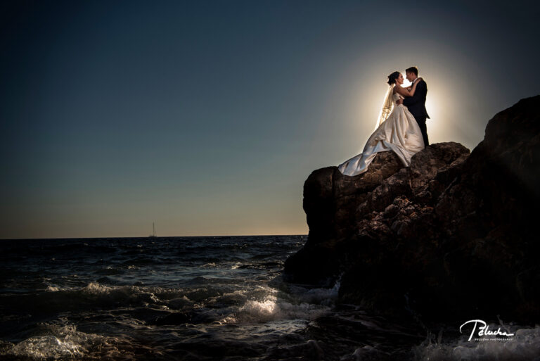 Couple silhouetted on a sea rock at dusk, destination wedding, Petr Pelucha Photography