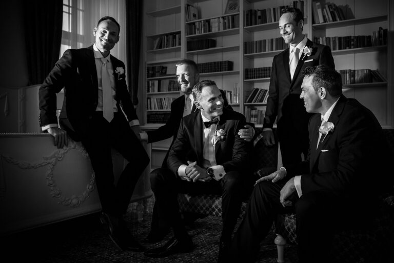 Groom and groomsmen in a library, black and white, Petr Pelucha Photography