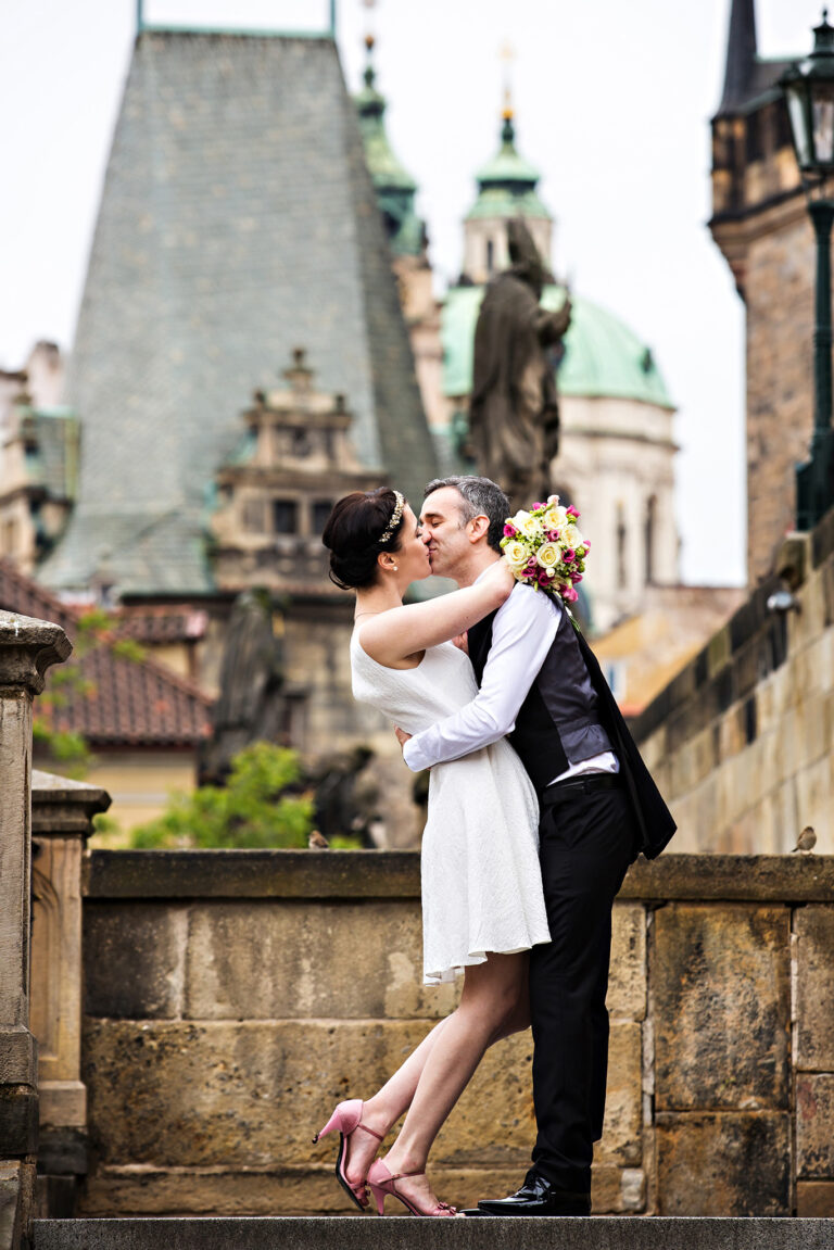 Couple on a Prague bridge with Baroque towers behind, Petr Pelucha Photography