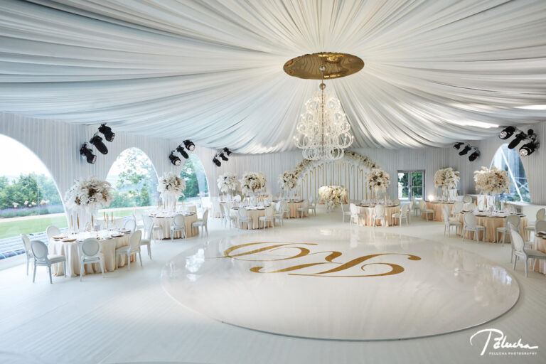 White draped marquee set for the reception with a monogrammed dance floor, Petr Pelucha Photography