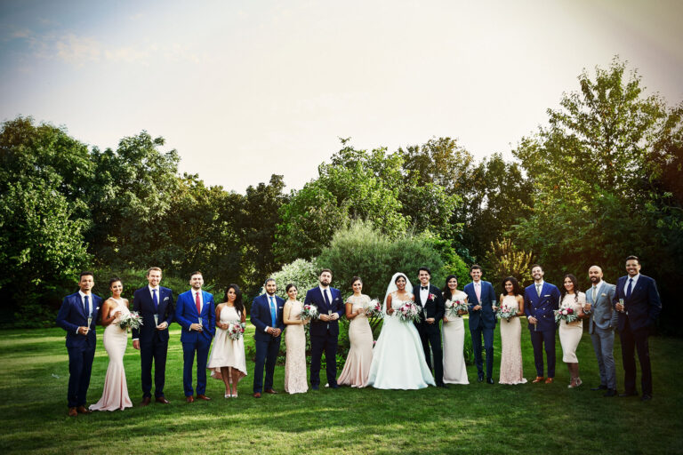 The full wedding party lined up on the lawn, Petr Pelucha Photography