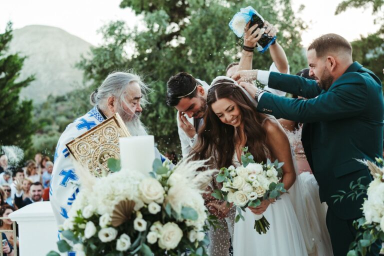 The priest and the best man crown the couple during an Orthodox ceremony, Photomad