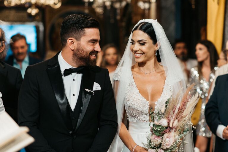 The couple smile together during the church ceremony, Photomad