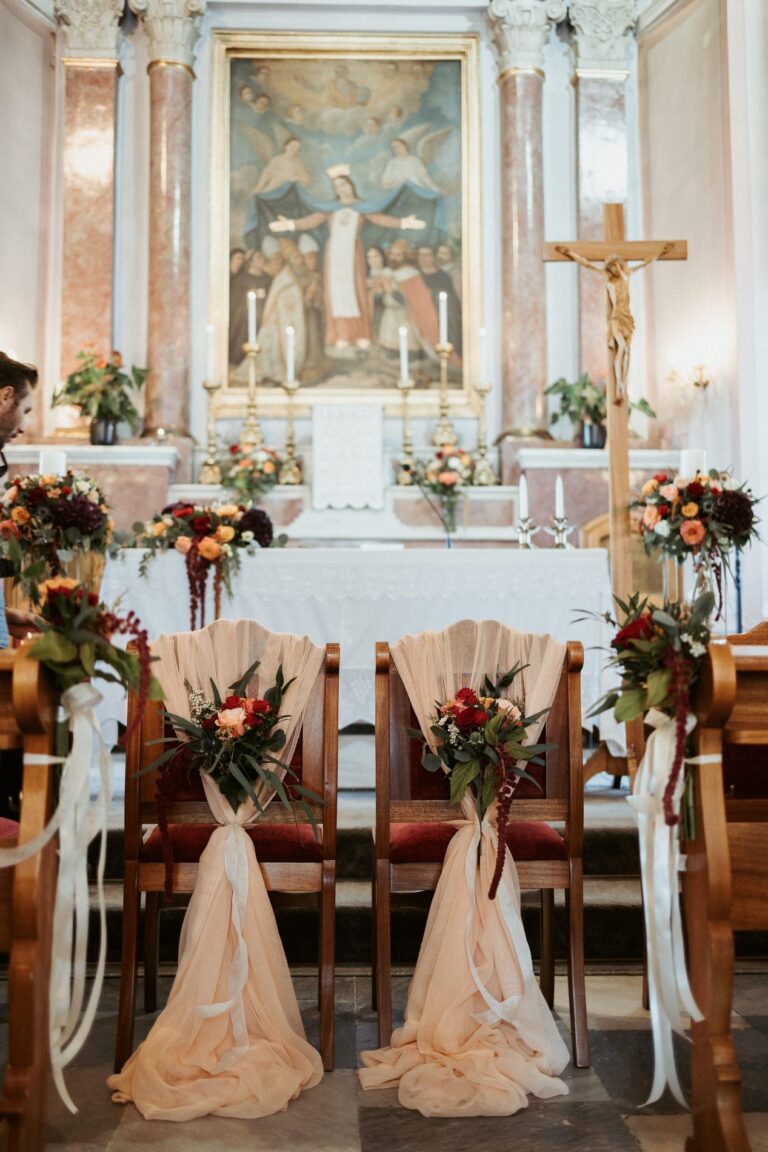 The altar and chairs dressed with flowers and ribbons inside a church, Photomad