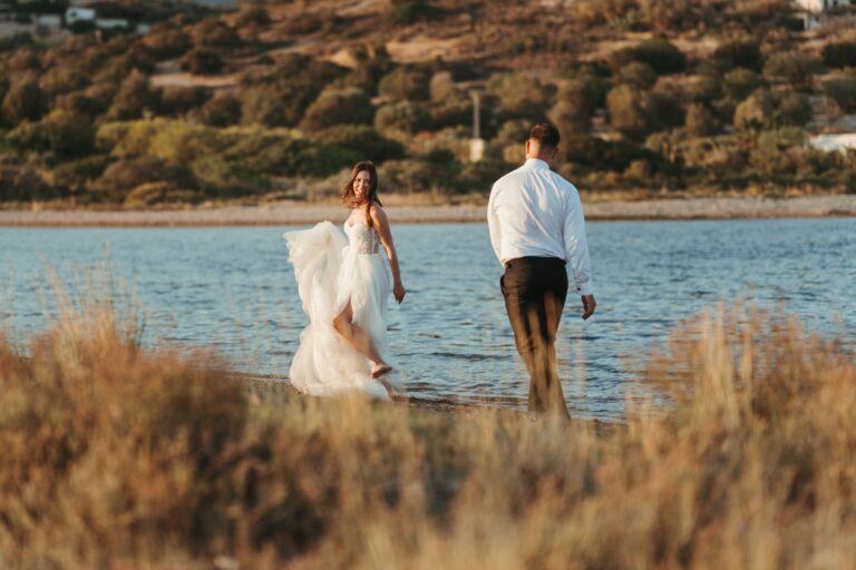 The couple walk along the shore at golden hour, Photomad