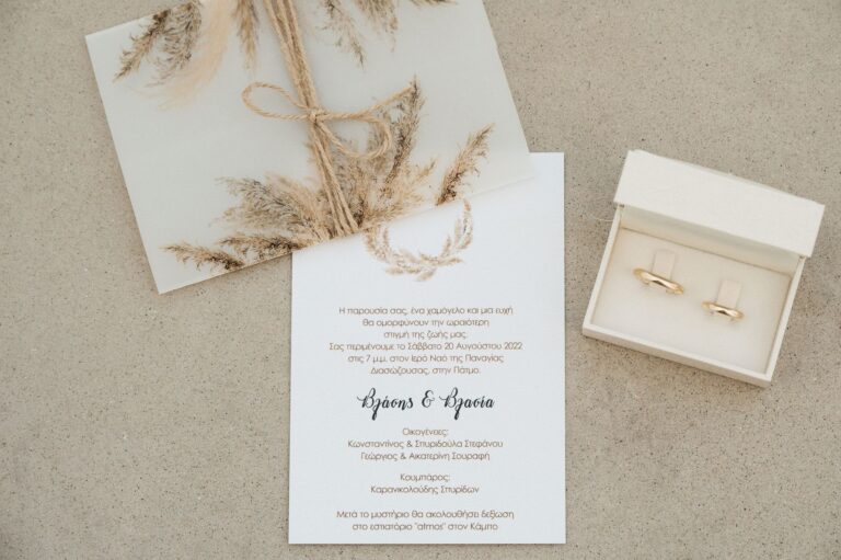 A wedding invitation and rings in an open box, Photomad