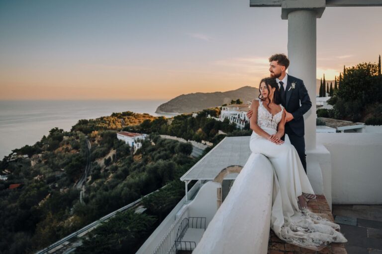 A couple on the terrace of La Locanda del Carrubo in Mattinata, the Gargano coast at dusk behind, Pino Coduti Photography