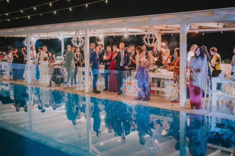 Guests gather beside the lit pool at La Locanda del Carrubo, Mattinata, Pino Coduti Photography