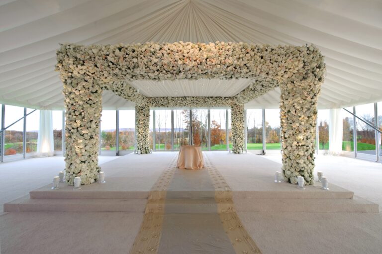 A ceremony chuppah of white flowers in a marquee overlooking a lawn, Preston Bailey