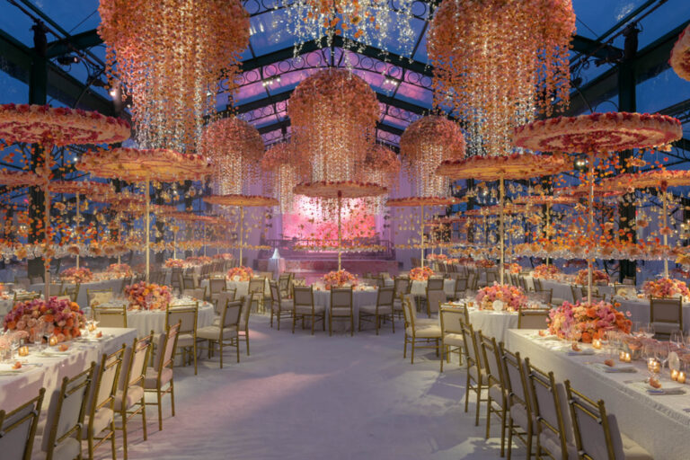 A marquee reception beneath hanging floral umbrellas in orange and peach, Preston Bailey