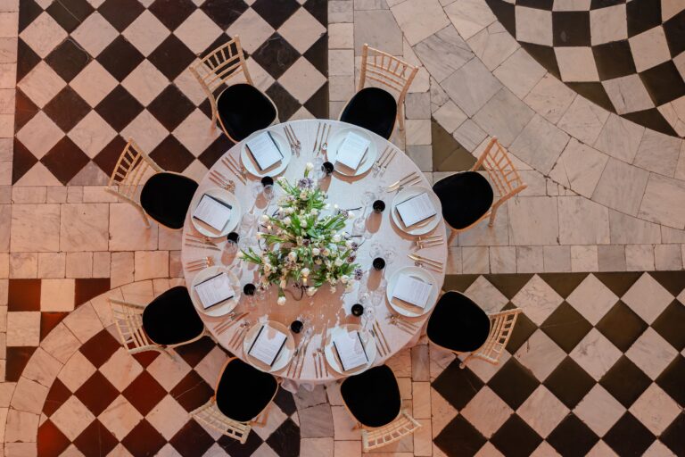 A round table laid on the marble floor, seen from above, Queen's House