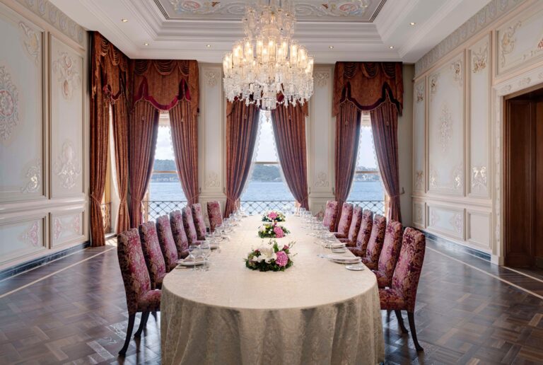 Long table laid in front of tall Bosphorus windows, Çırağan Palace Kempinski Istanbul