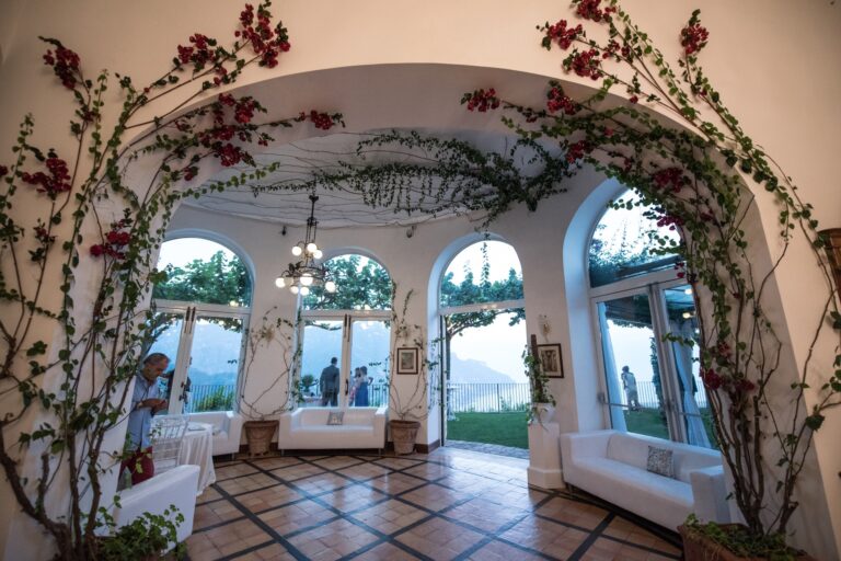An arched loggia hung with climbing roses, three arches of sea beyond it, Ramona Avitabile Wedding Planner