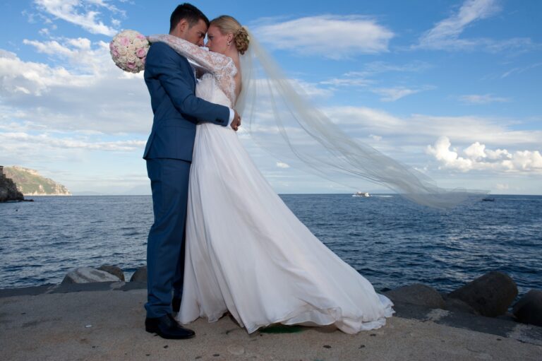 At the water's edge, the veil lifting off the sea wall, Ramona Avitabile Wedding Planner