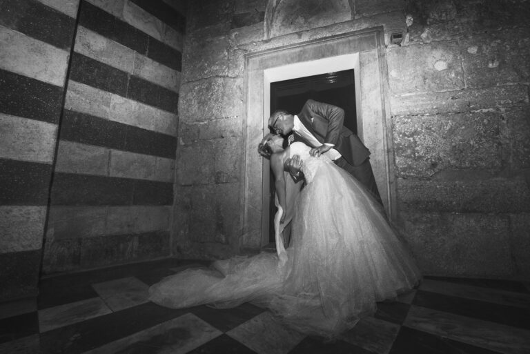 The dip in the doorway, in black and white, striped stone all around them, Ramona Avitabile Wedding Planner