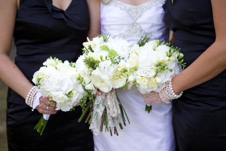 A bride and her bridesmaids with white hand-tied bouquets, Rebecca Mays