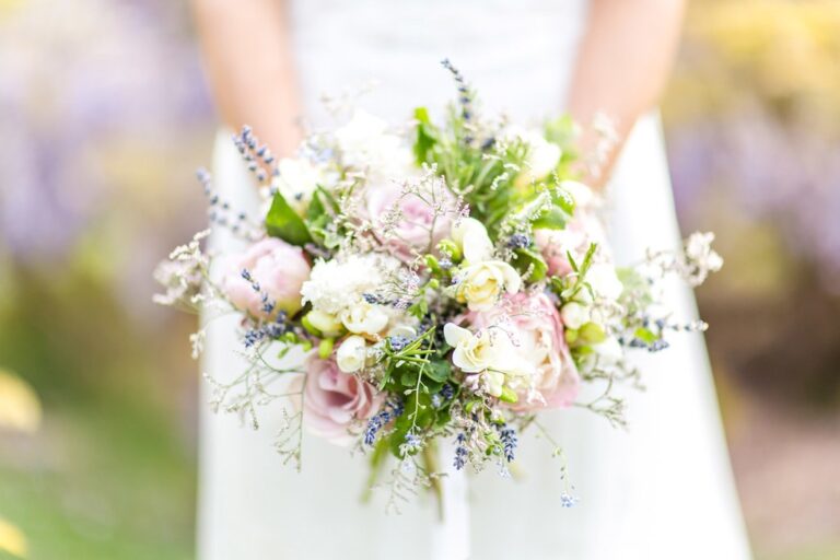 A bouquet detail in blush and lavender, against wisteria. Photograph by Eddie Judd Photography, Rebecca Mays