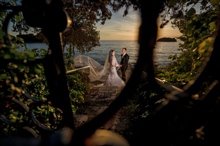Couple on the Rovinj seafront at sunset, seen through ironwork, Reflexion Studio