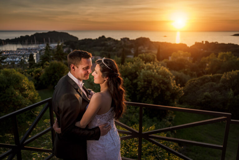 Couple on a terrace at sunset above a harbour, Reflexion Studio