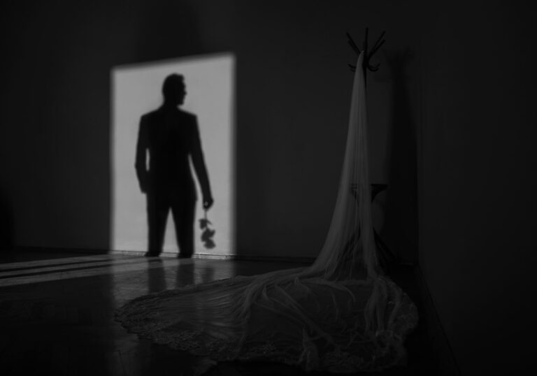 Groom's shadow and the bride's long veil in a darkened room, Reflexion Studio