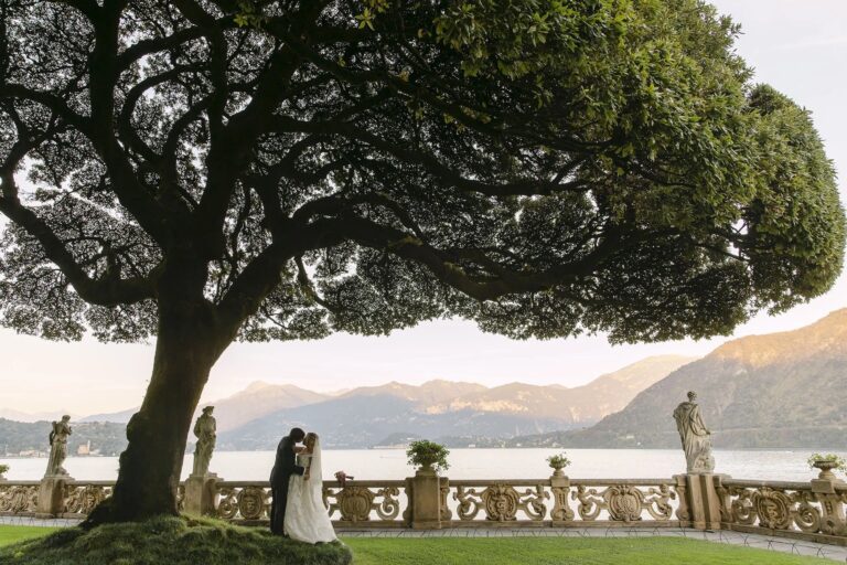 A couple beneath the great tree on the terrace of Villa del Balbianello, the lake and mountains beyond, Rellini Art Studio