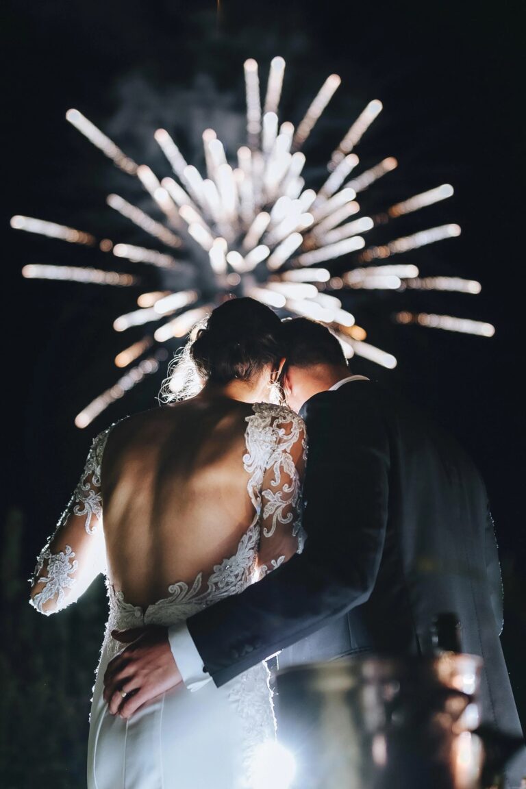 Bride and groom embrace as fireworks burst overhead, Castello di Petrata, Umbria, Rellini Art Studio