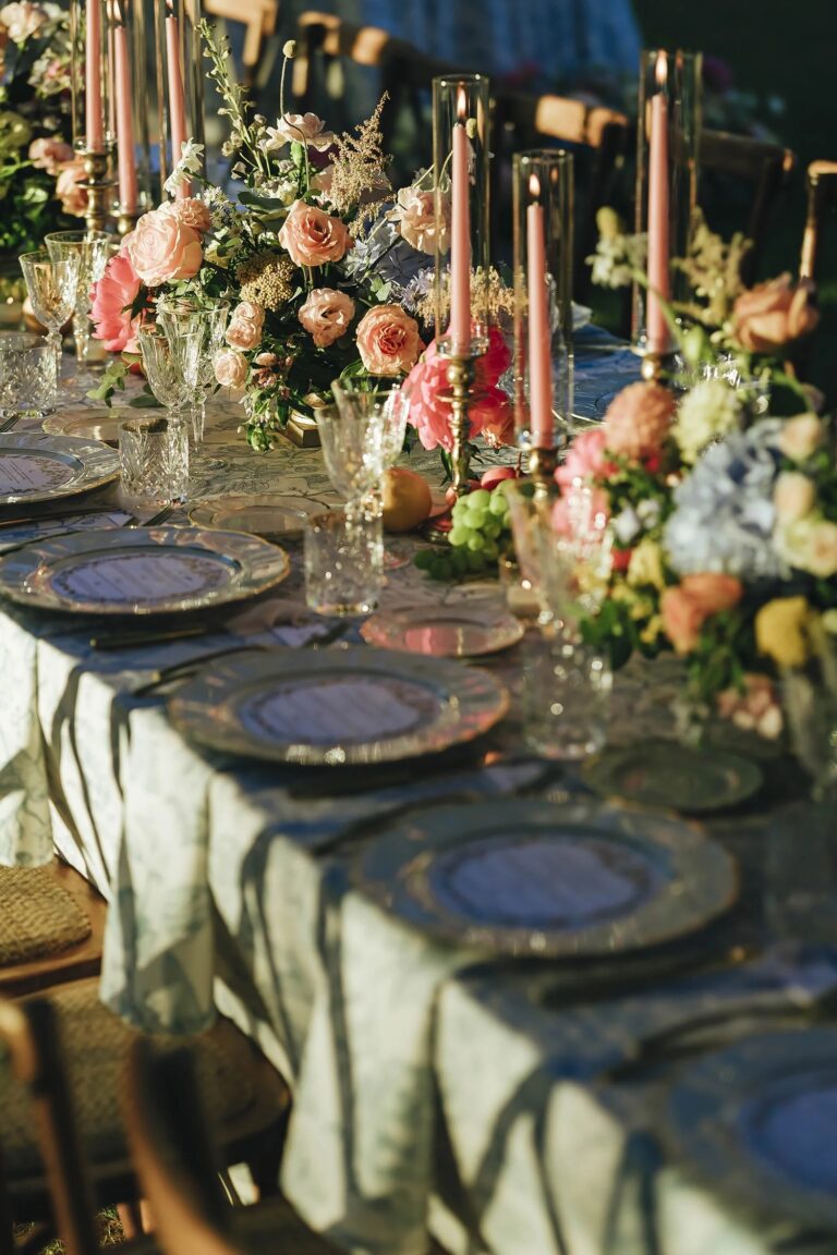 A table laid with flowers, candles and patterned plates for a wedding dinner in Tuscany, Rellini Art Studio