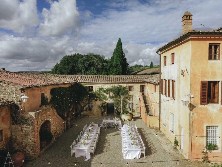 Dinner tables laid in the courtyard at Villa Catignano, Tuscany, Rellini Art Studio