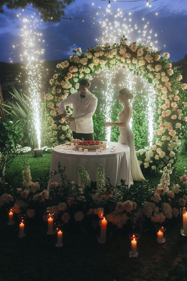 Cutting the cake under a floral arch with fountain fireworks, Lake Como, Rellini Art Studio