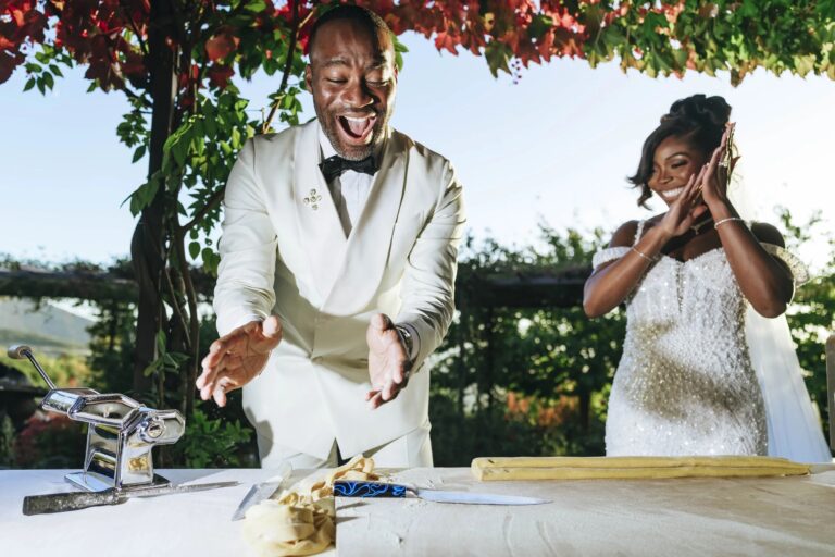 A burst of laughter from the couple at a pasta-making station on the terrace, Castello di Petrata, Umbria, Rellini Art Studio