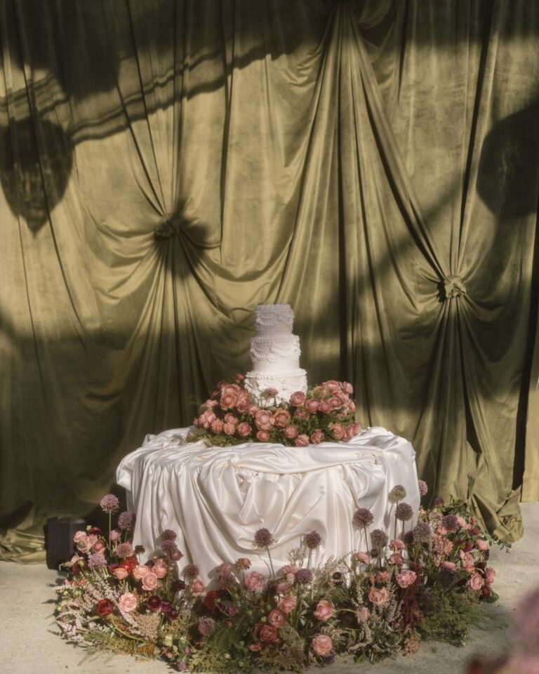 Wedding cake on a draped table ringed with florals, Aspen, Revelry Event Designers