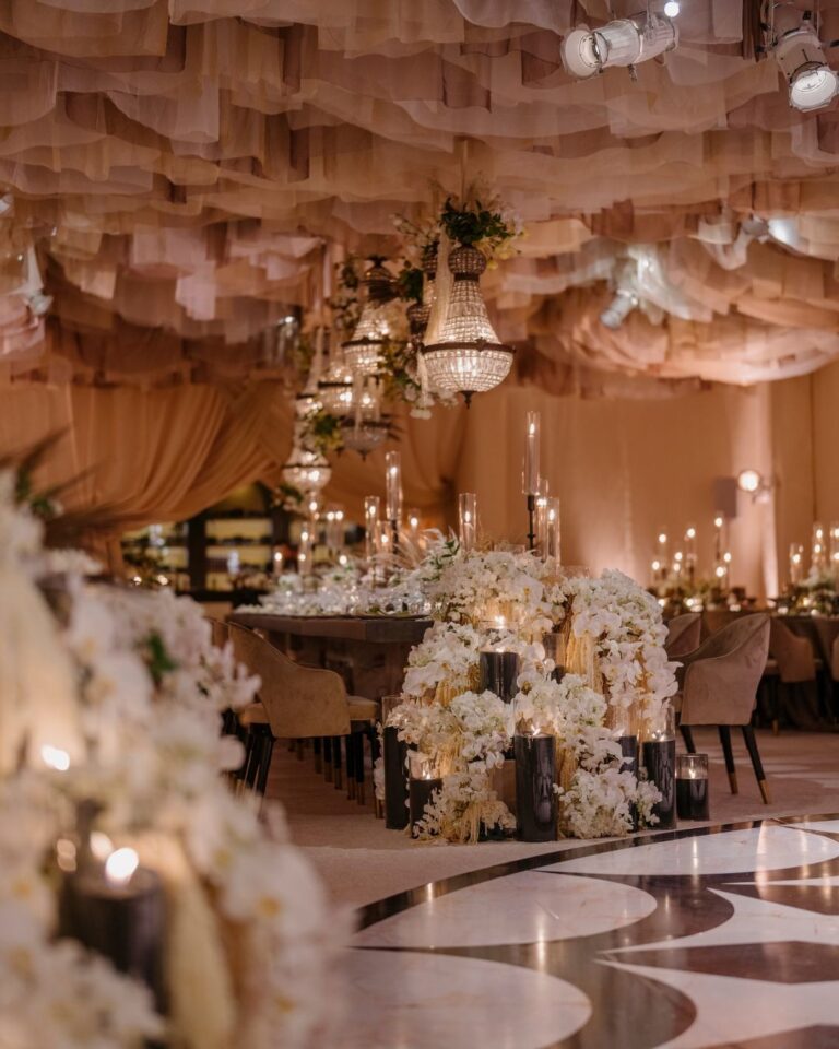 Draped reception with chandeliers and florals, Pelican Hill, Revelry Event Designers