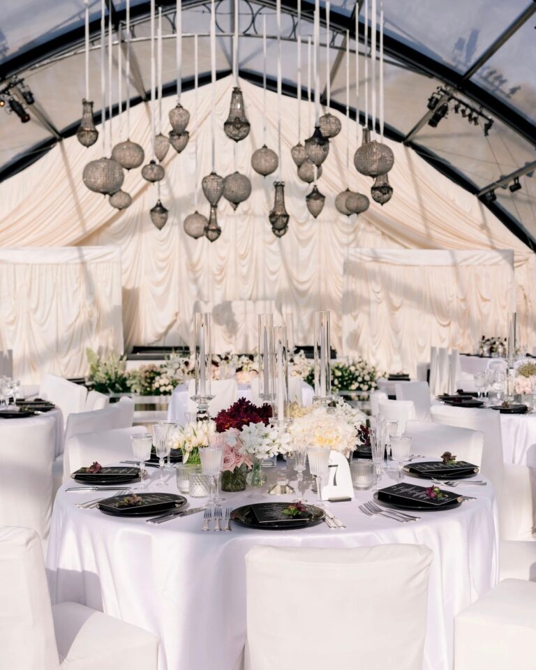 Pierced lanterns hung beneath ivory fabric in the reception tent, Santa Barbara, Revelry Event Designers