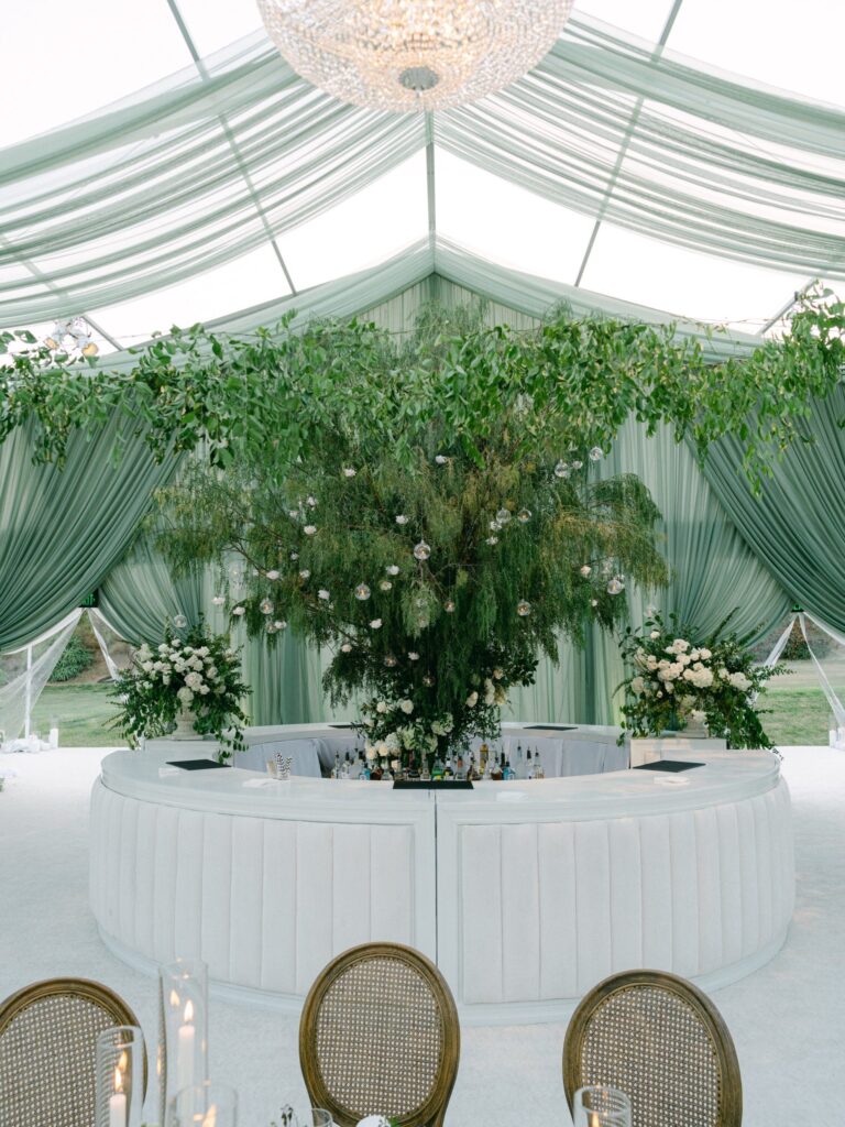 Curved head table inside a draped reception tent, Revelry Event Designers